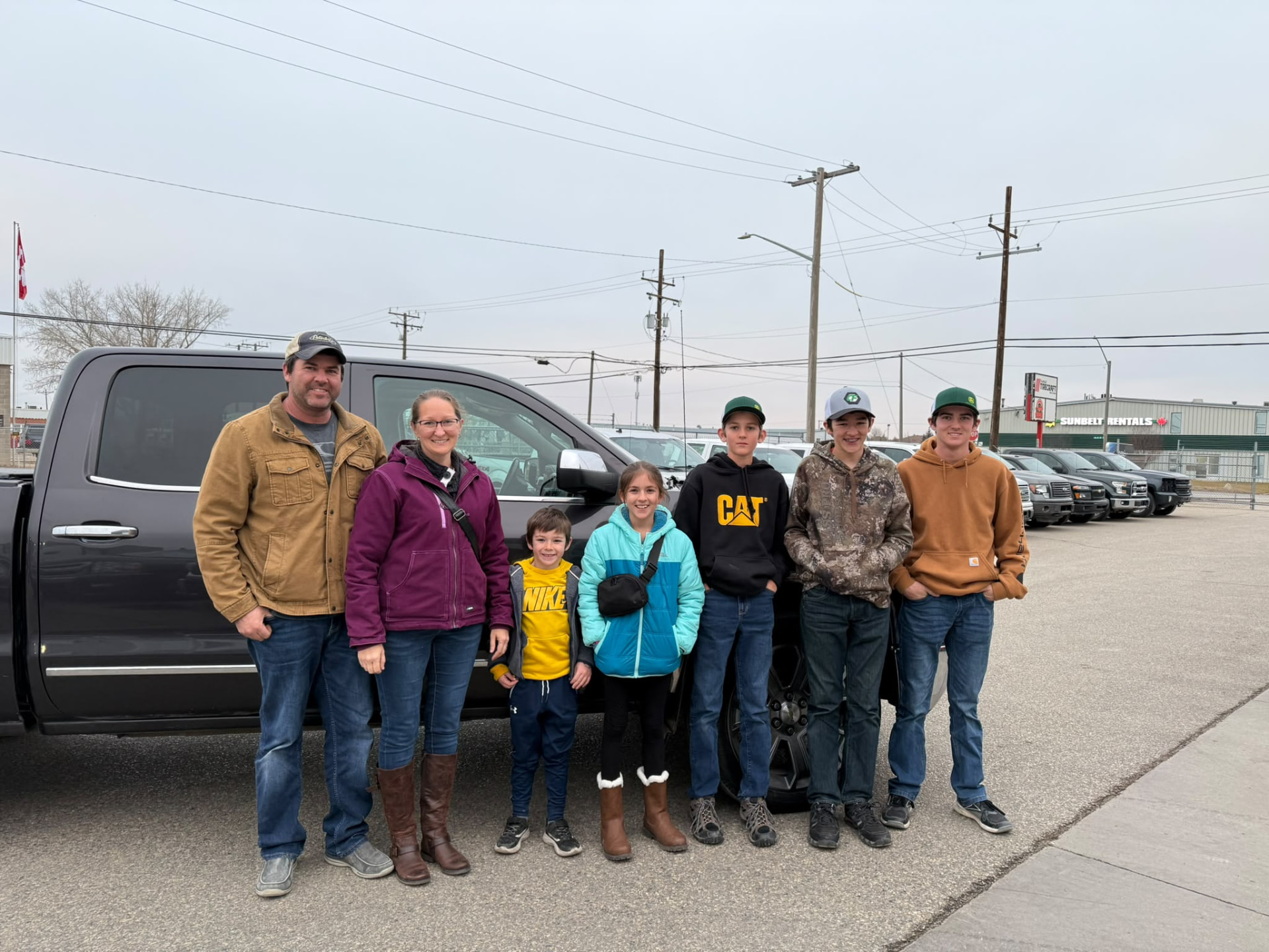 Happy Orange Auto customer with their vehicle