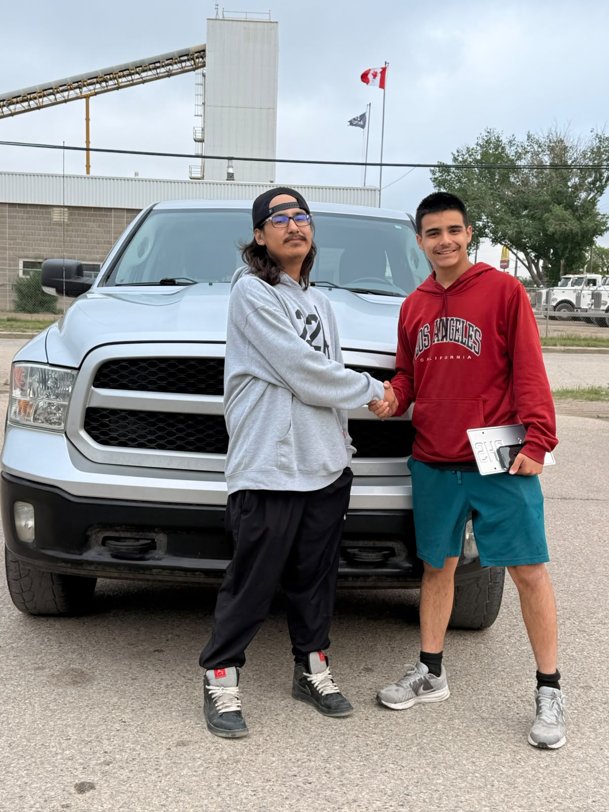 Happy Orange Auto customer with their vehicle