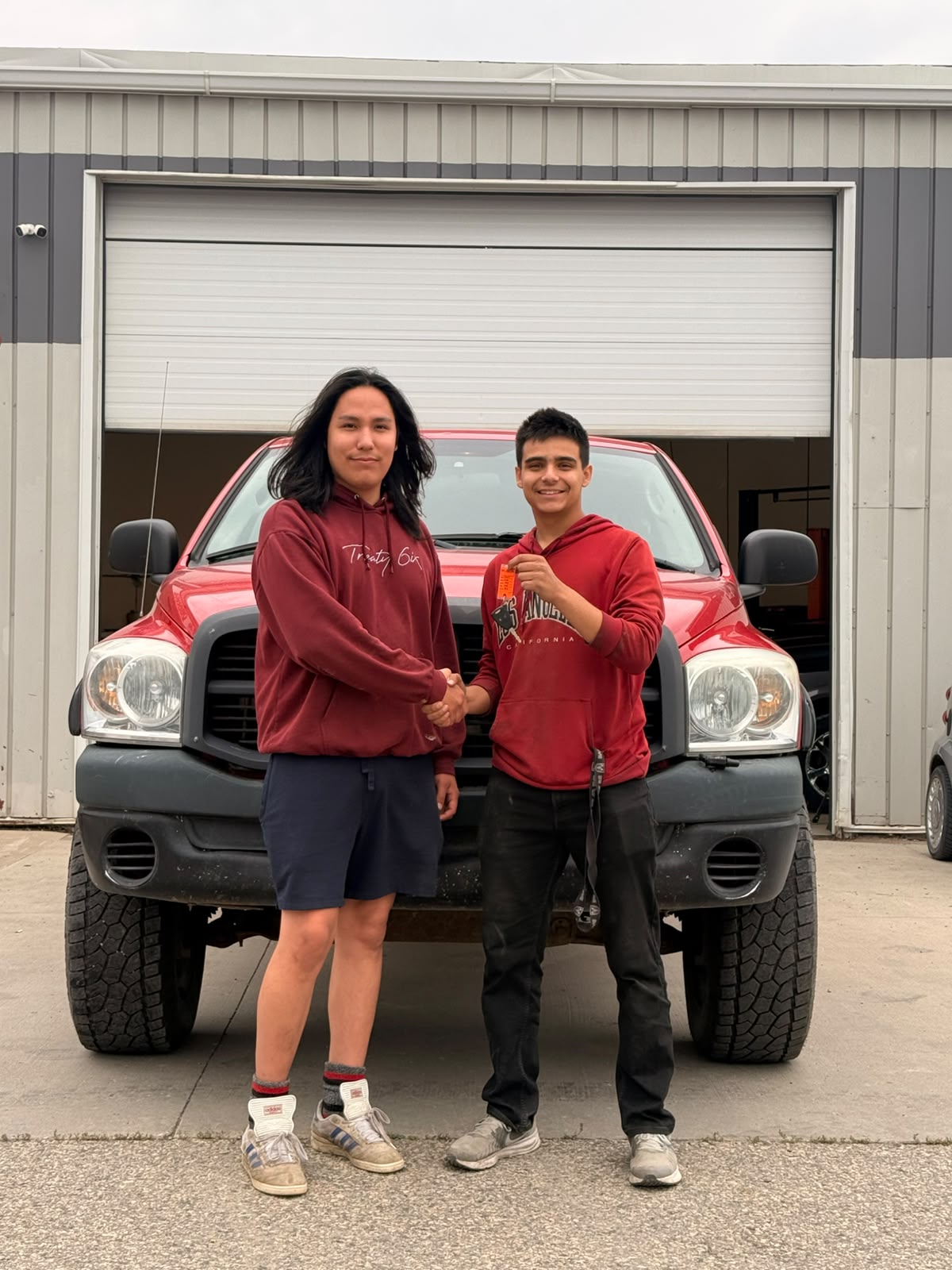 Happy Orange Auto customer with their vehicle