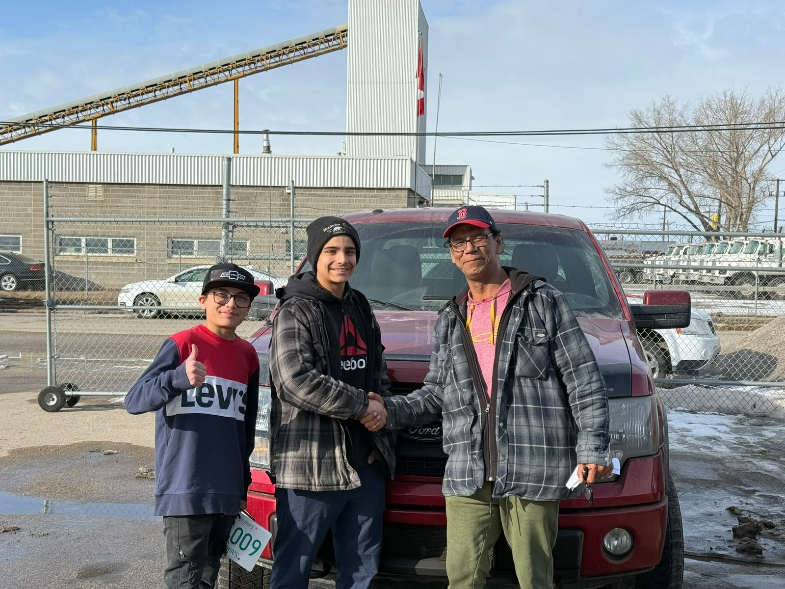 Happy Orange Auto customer with their vehicle
