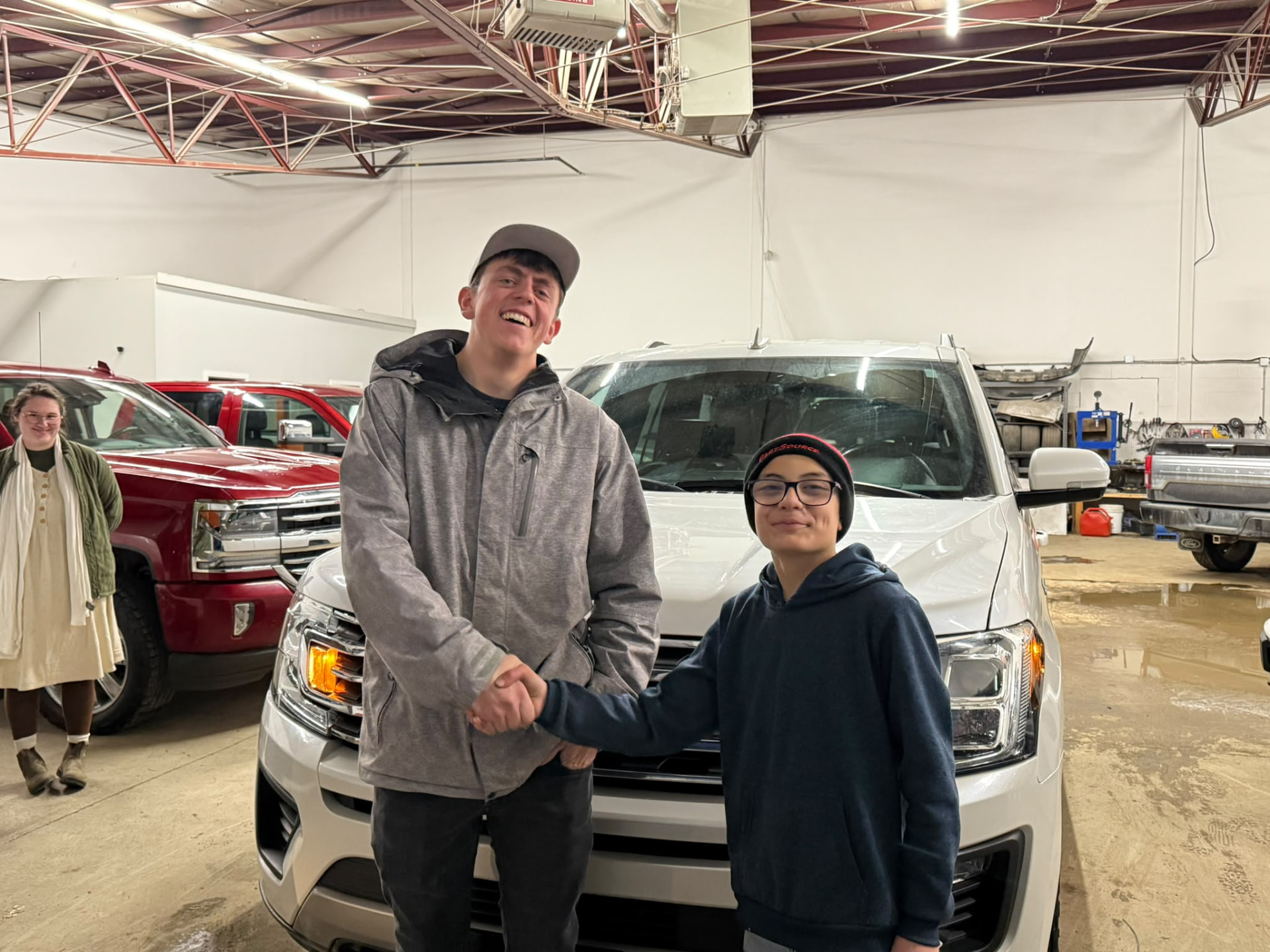 Happy Orange Auto customer with their vehicle